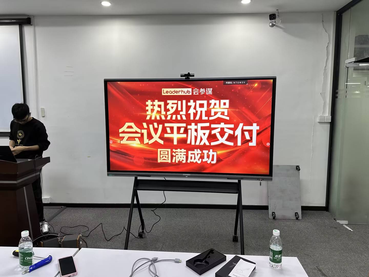 Team using an interactive flat panel display for a video conference