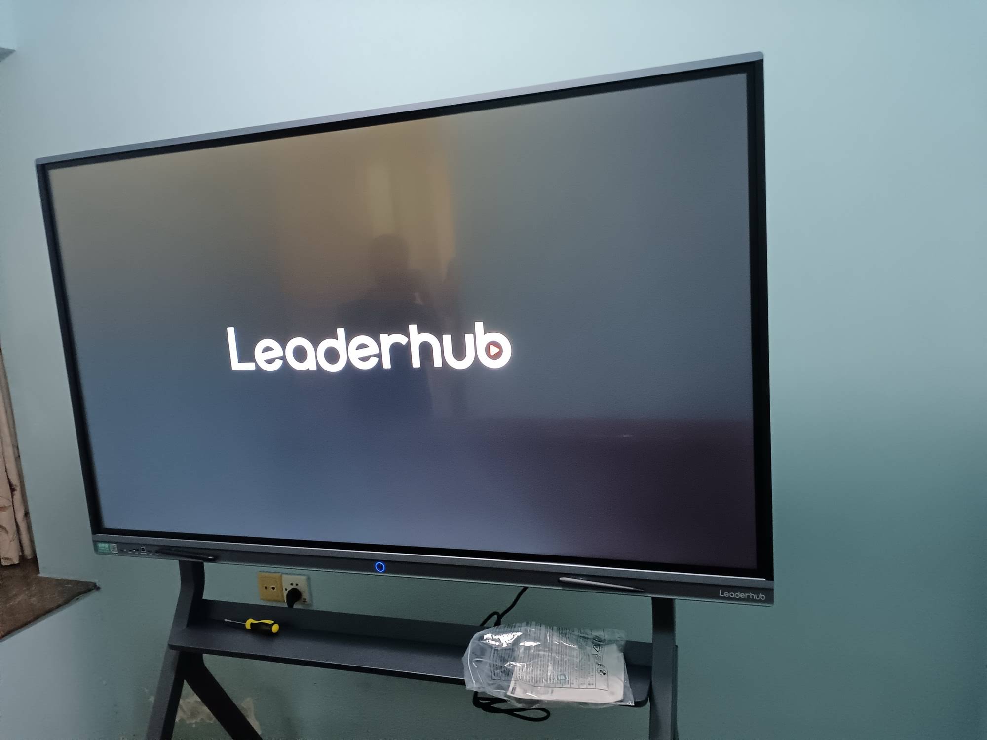 Student interacting with smart board displaying educational content