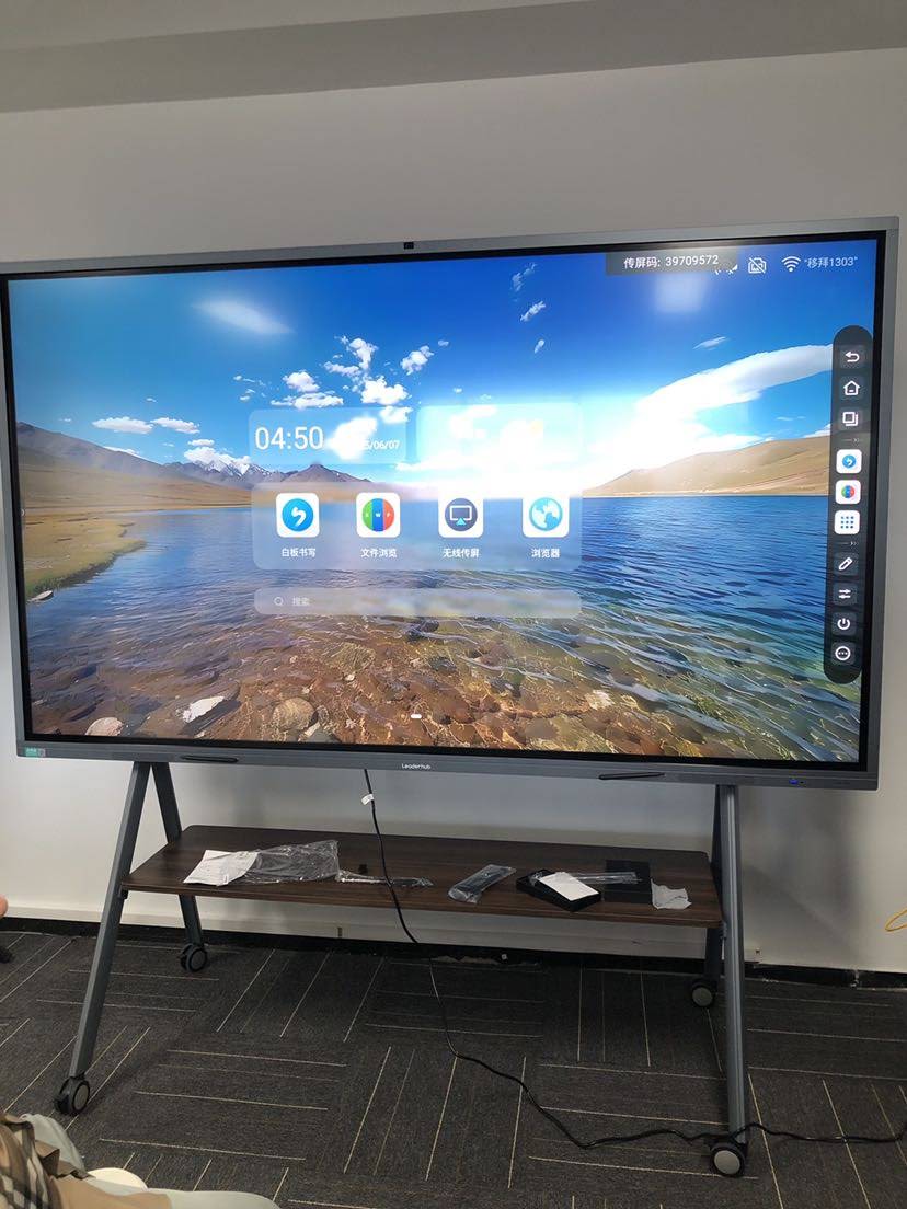 Educator cleaning smart board touch screen with microfiber cloth
