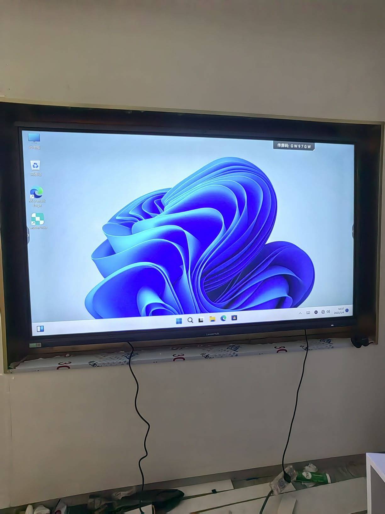 Team collaborating around a large interactive flat panel in a meeting room