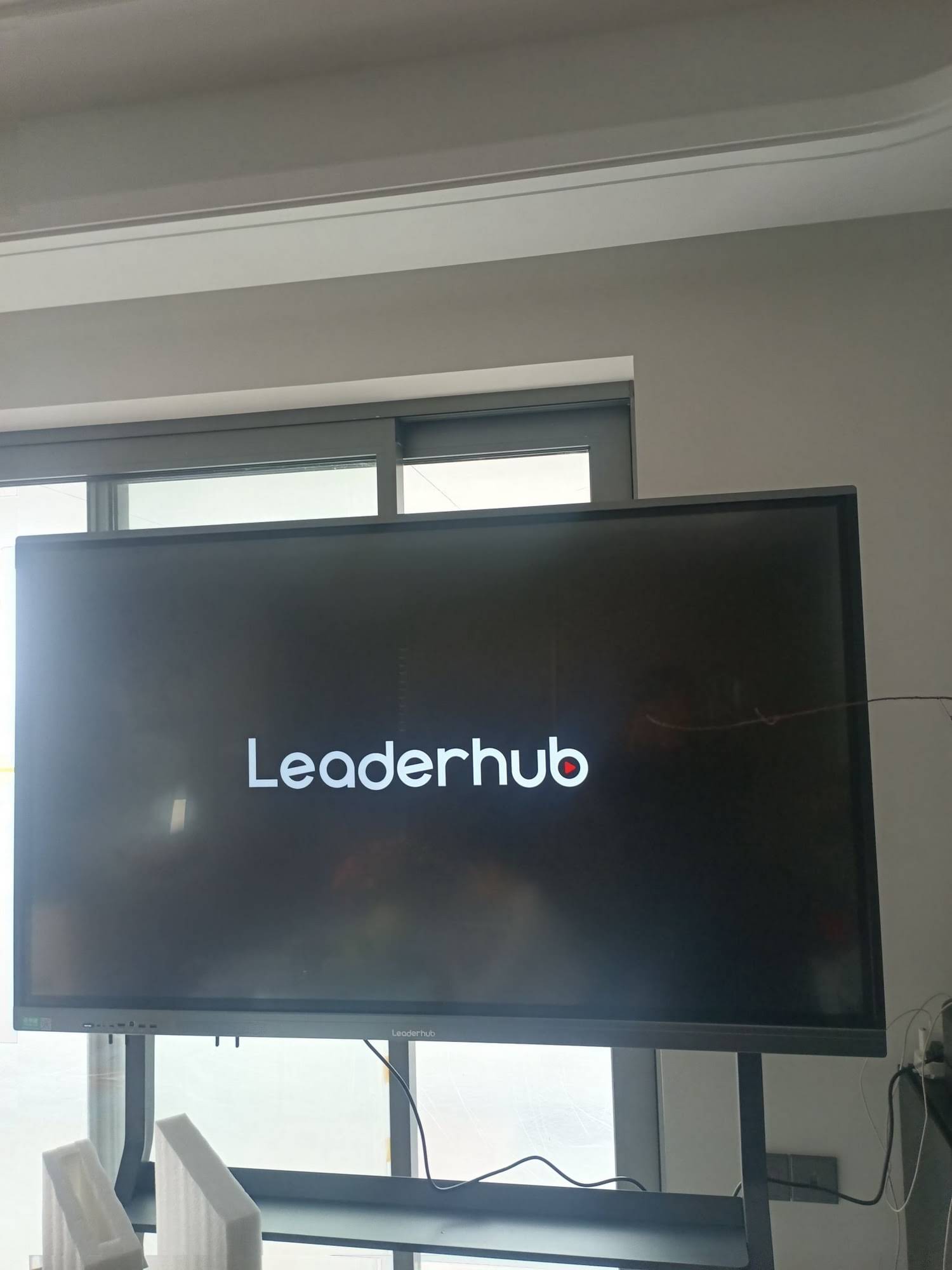 Classroom teacher using smart whiteboard with dual-system touchscreen