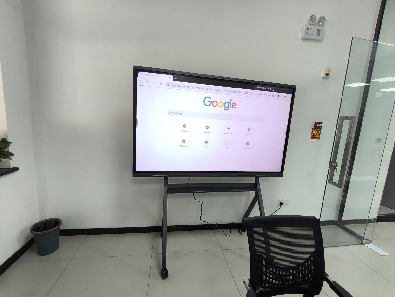 Team collaborating on a large interactive flat panel during a business meeting