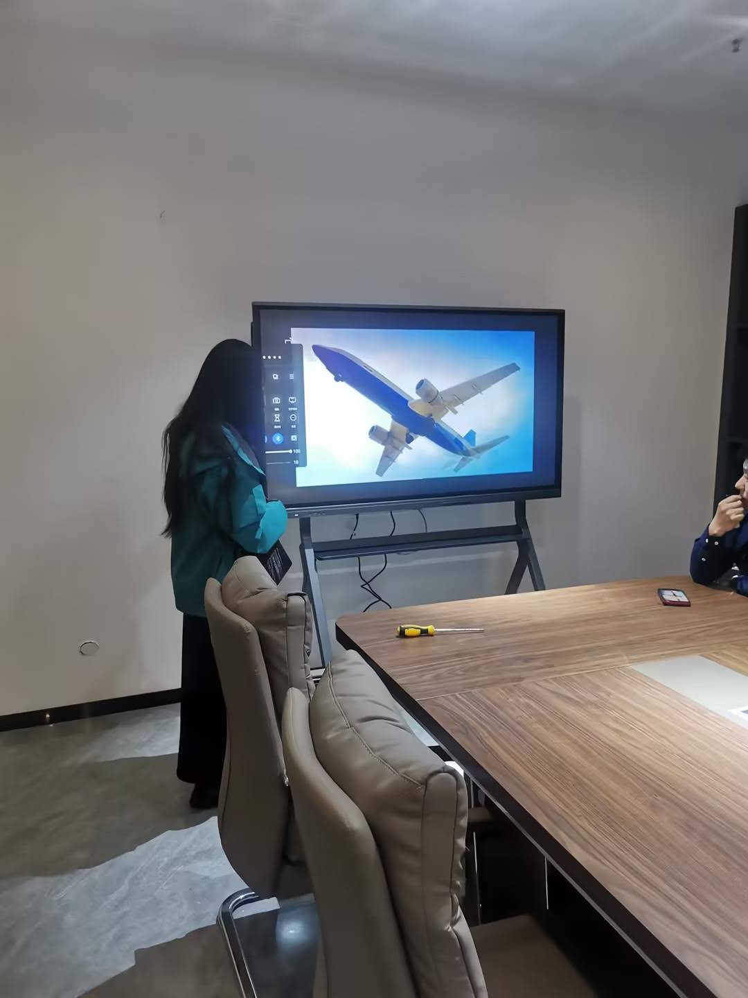 Teacher using smart board AI features for interactive lesson with students