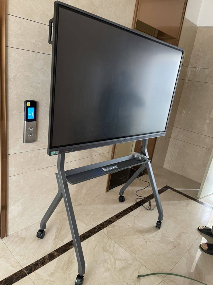 Close-up of a smart board interface and laptop connection setup