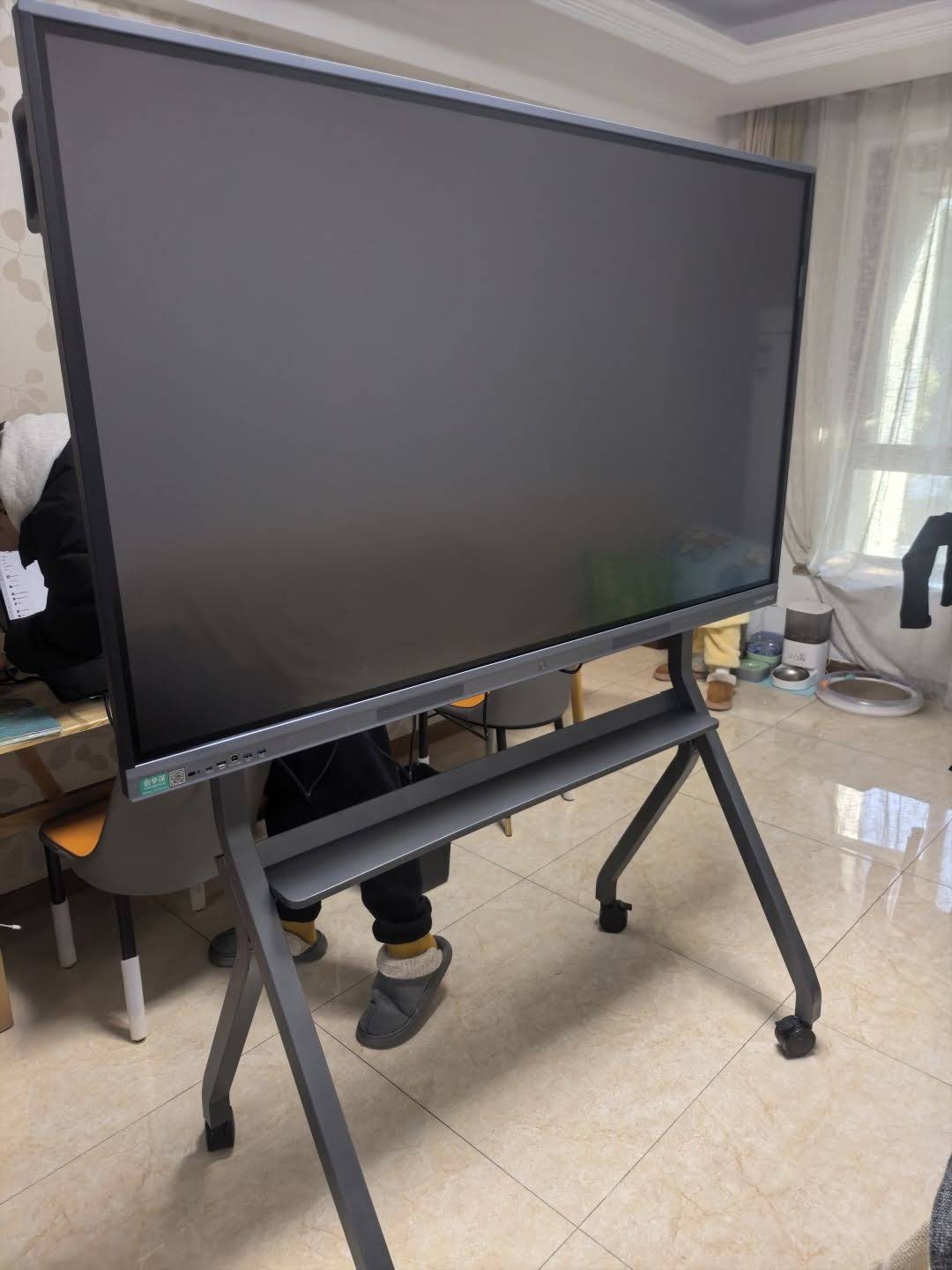Teacher using smart board touch interface in classroom environment