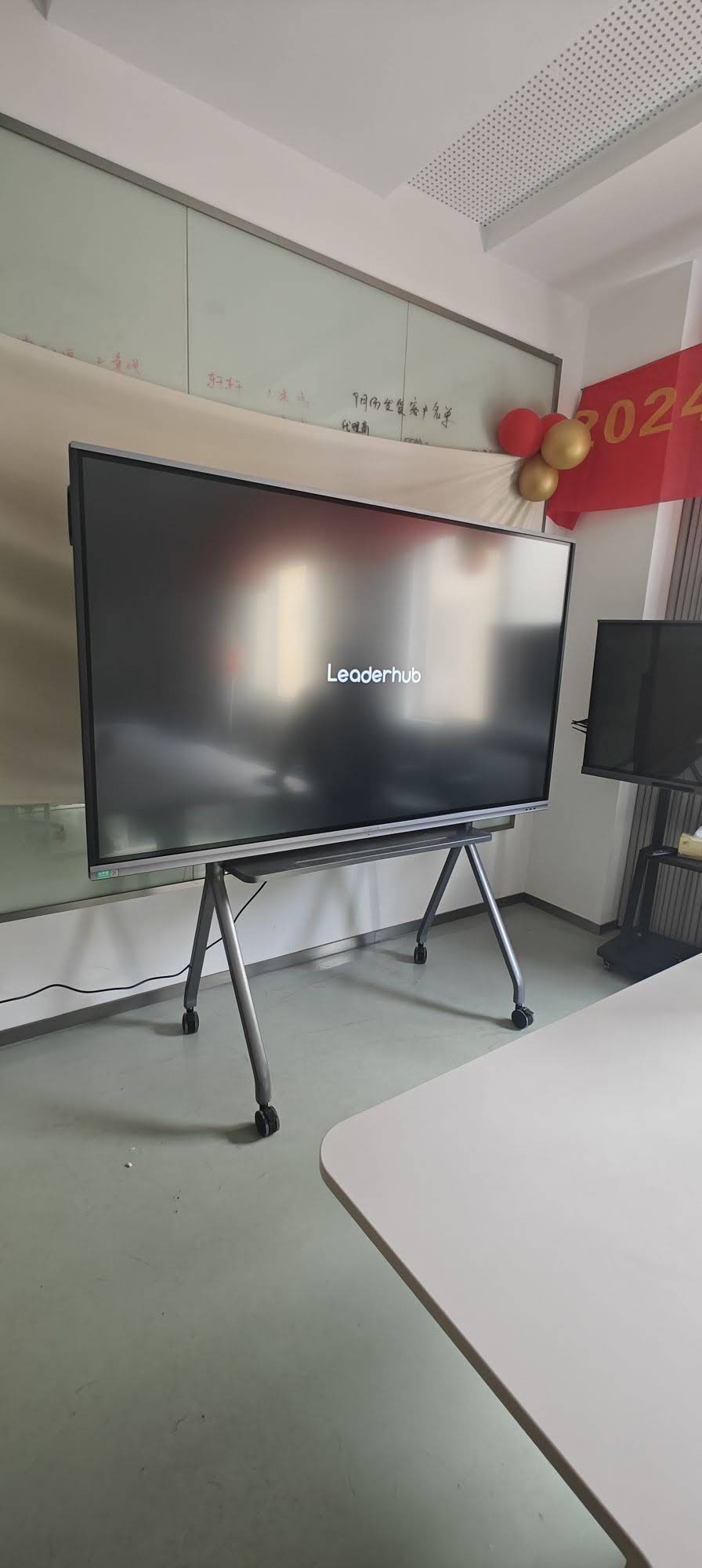 Large format interactive smart whiteboard displaying 4K content in corporate meeting room