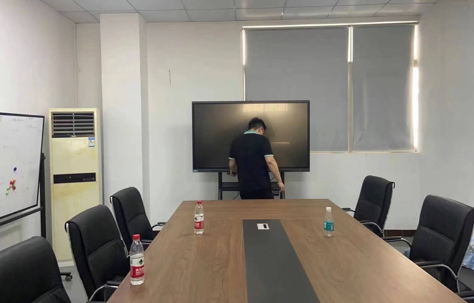 Business team using wireless screen sharing smart whiteboard during meeting